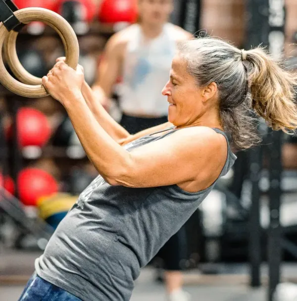 Trainer coaching a new member 1-on-1 through CrossFit fundamentals